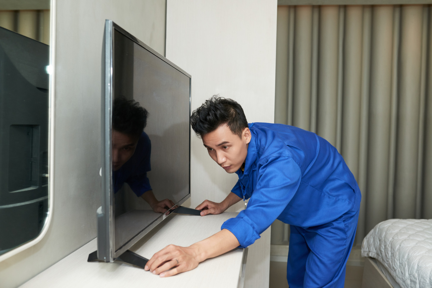 Man adjusting tv